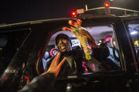 <p>Stevante Clark the brother of Stephon Clark is given flowers as he stopped in an SUV at the intersection of Florin and 29th Street during a vigil for his brother in Sacramento, Calif., on Fri., March 23, 2018. His brother Stephon was unarmed when he was shot and killed by Sacramento Police in his grandparents back yard. (Photo: Renée C. Byer/Sacramento Bee via ZUMA Wire) </p>