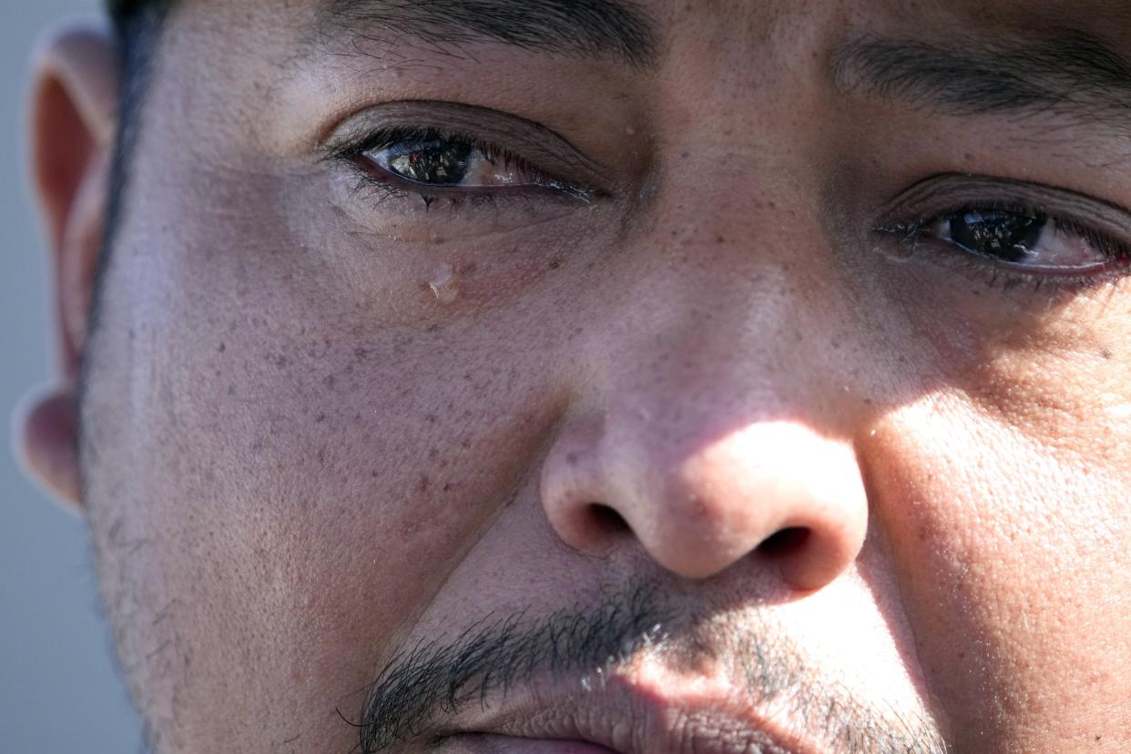 FILE - Mass shooting survivor Wilson Garcia sheds a tear as he talks about his wife and son, who were killed in a mass shooting days earlier, at a vigil for his son in Cleveland, Texas, April 30, 2023. The litany of Texas’ mass killings in just the last few years is staggering — one of which occurred in Cleveland when five people were killed on April 28. Guns have long been a part of Texas culture, but to equate the number of guns with the number of people killed by guns strikes some as a false equivalence. (AP Photo/David J. Phillip, File)
