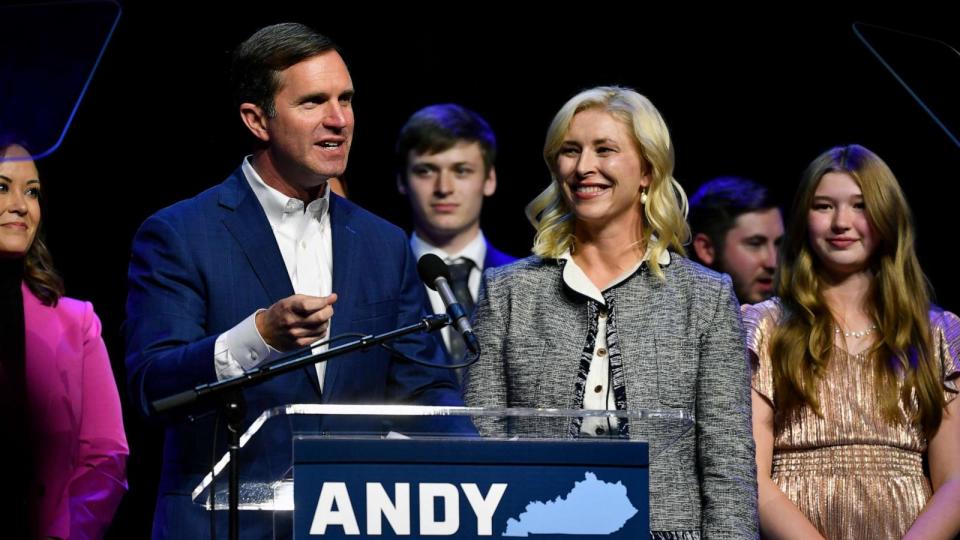 PHOTO: Kentucky Gov. Andy Beshear speaks during an election night rally after he was elected to a second term in Louisville, Ky., Nov. 7, 2023. At right is his wife Britainy Beshear. (Timothy D. Easley/AP)