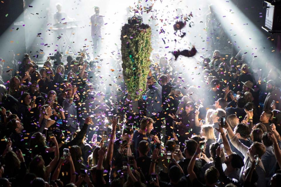 A depiction of a cannabis bud drops from the ceiling at Leafly's countdown party in Toronto (Chris Young/AP)
