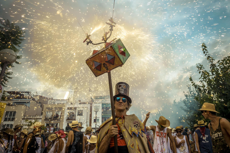 <p>Beim „Festa Major de Sitges“ im spanischen Ort Sitges entzündet ein kostümierter Mann ein Feuerwerk über seinem Kopf. Bei dem jährlichen Umzug werden der Heilige Bartholomäus sowie die Heilige Thekla geehrt. (Bild: Matthias Oesterle/ZUMA Wire/dpa) </p>