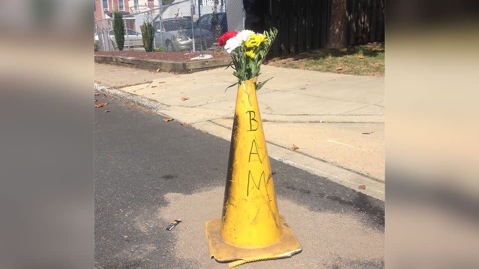 Flowers lie at the scene of where Delaware police officers fatally shot an armed man in a wheelchair. Photo: AP/Randall Chase