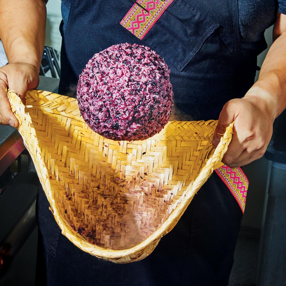 Giving his Purple Sticky Rice a toss.