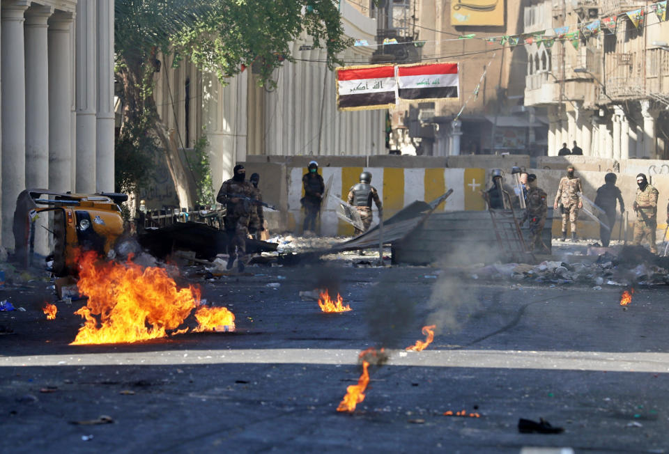 Iraqi riot police fire tear gas to disperse anti-government protesters during clashes in the al-Rasheed street in Baghdad, Iraq, Friday, Nov. 8, 2019. The demonstrators complain of widespread corruption, lack of job opportunities and poor basic services, including regular power cuts despite Iraq's vast oil reserves. They have snubbed limited economic reforms proposed by the government, calling for it to resign. (AP Photo/Khalid Mohammed)