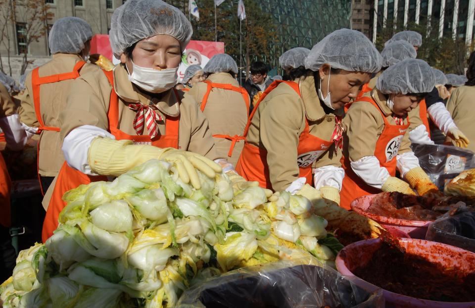 SEOUL, SOUTH KOREA - NOVEMBER 15: More than two thousand housewives make Kimchi for donation to the poor in preparation for winter in front of City Hall on November 15, 2012 in Seoul, South Korea. Kimchi is a traditional Korean dish of fermented vegetables usually mixed with chili and eaten with rice or served as a side dish to a main meal. (Photo by Chung Sung-Jun/Getty Images)