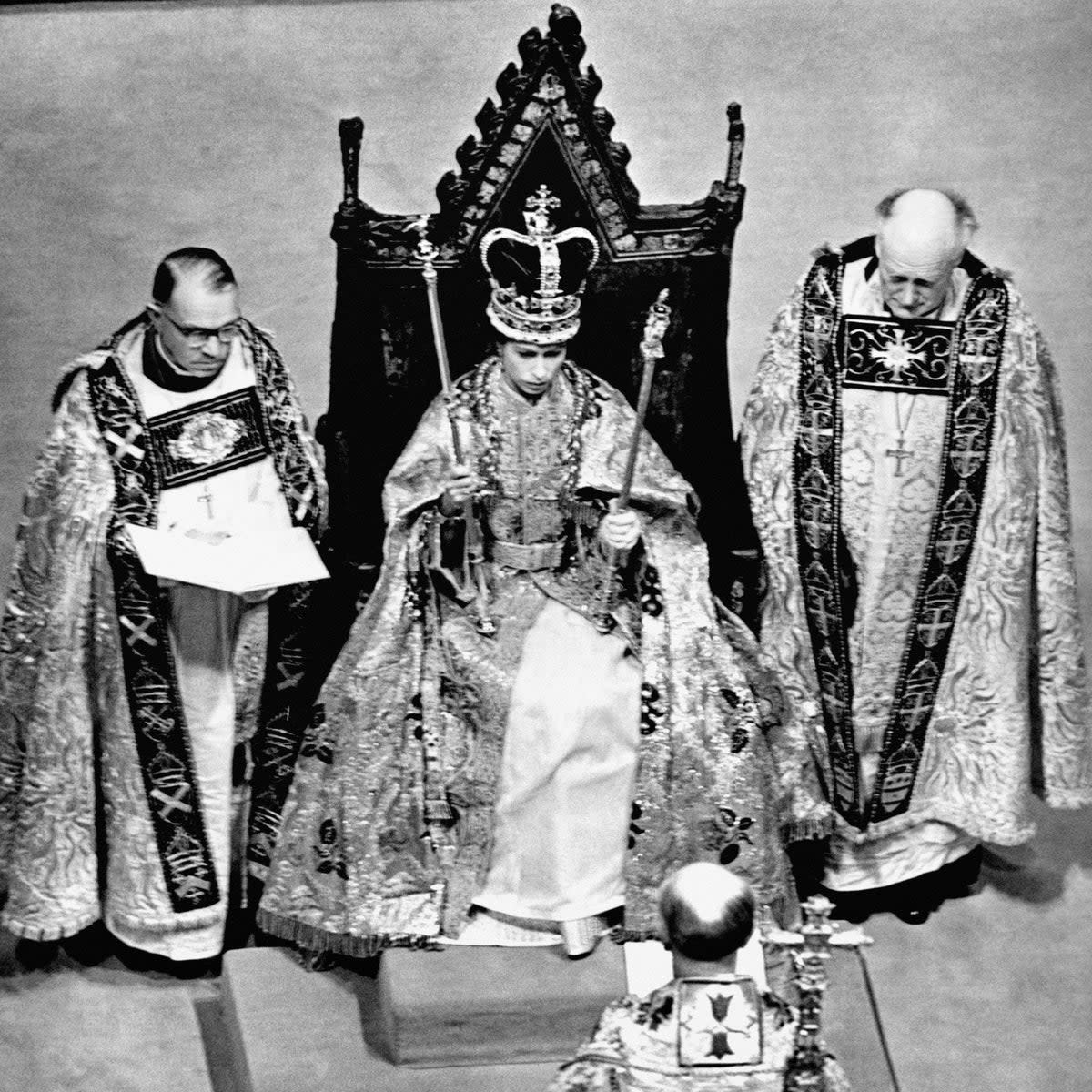 Queen Elizabeth II wearing the St. Edward Crown and carrying the Sceptre and the Rod after her coronation in Westminster Abbey, London (PA)