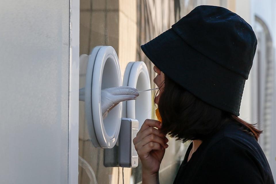 A woman undergoes a Covid-19 test in Beijing (EPA)