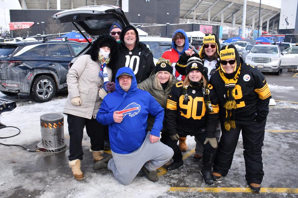 Buffalo Bills and Pittsburgh Steelers fans pose for a photo outside Highmark Stadium on Monday before the AFC wild-card game in Orchard Park, New York.