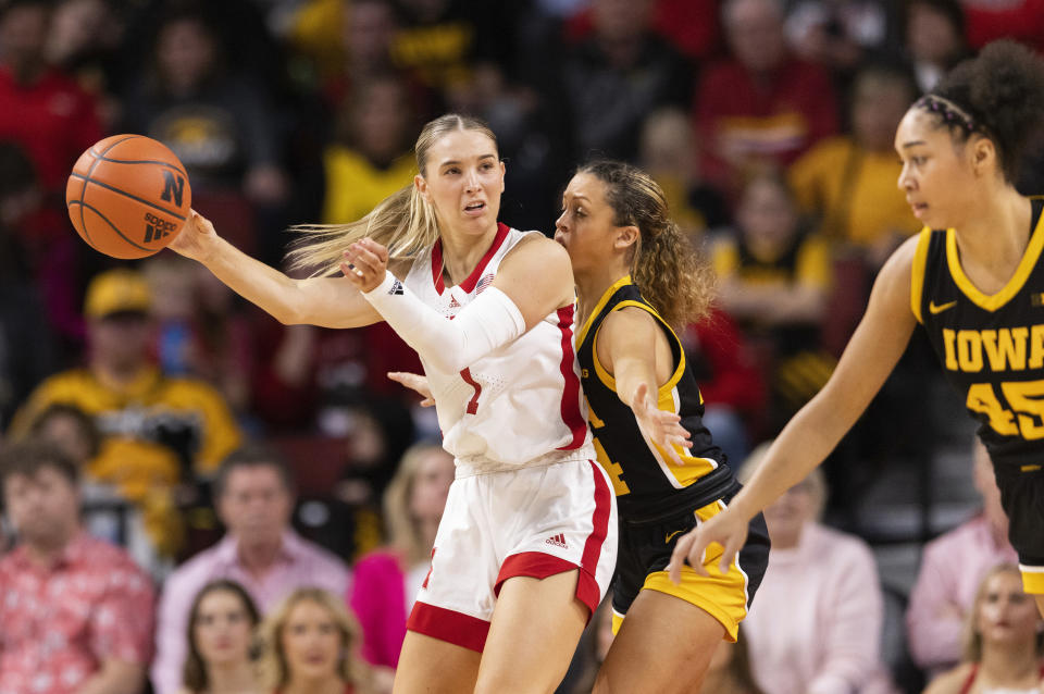 Nebraska's Jaz Shelley, left, drives against Iowa's Gabbie Marshall, center right, during the second half of an NCAA college basketball game Sunday, Feb. 11, 2024, in Lincoln, Neb. (AP Photo/Rebecca S. Gratz)