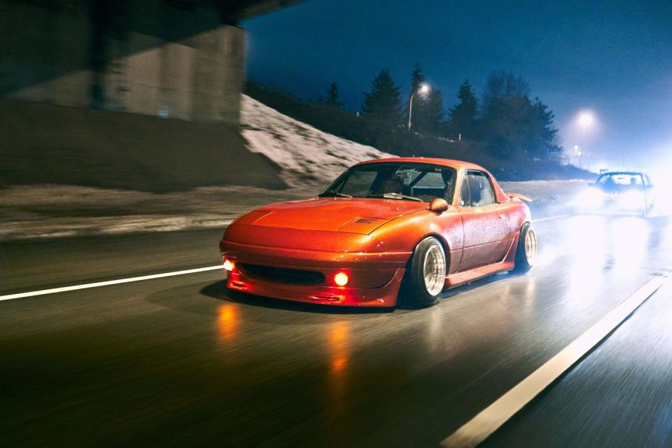 orange car on a wet highway