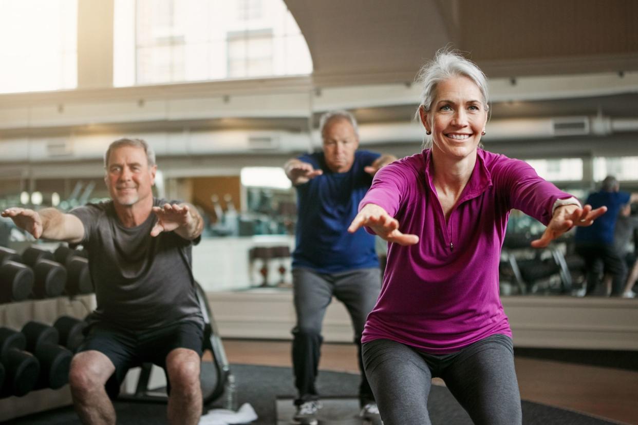 middle-aged folks doing squats