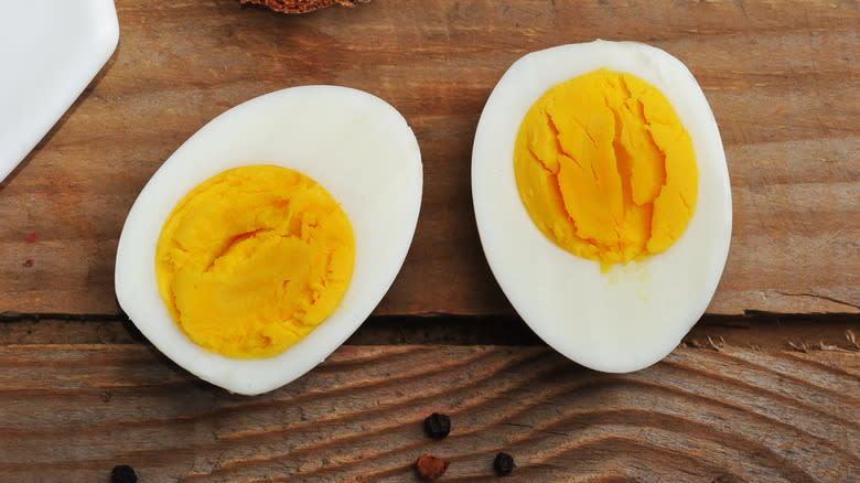 Hard boiled eggs on wooden surface