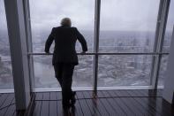 FILE - In this Friday, Feb. 1, 2013 file photo then London mayor Boris Johnson poses for photographers by looking out at the sights after officially opening "The View" viewing platform at the Shard skyscraper in London. (AP Photo/Matt Dunham, File)