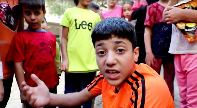 13-Year-Old Gazan British passport holder, Omran Abu Assi, talks during an interview with Reuters