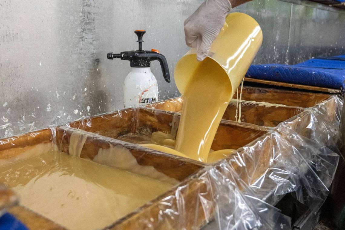 The soap mixture is poured into wooden trays after combining the ingredients to create a batch of frankincense-lavenderr Zum Bar soaps.