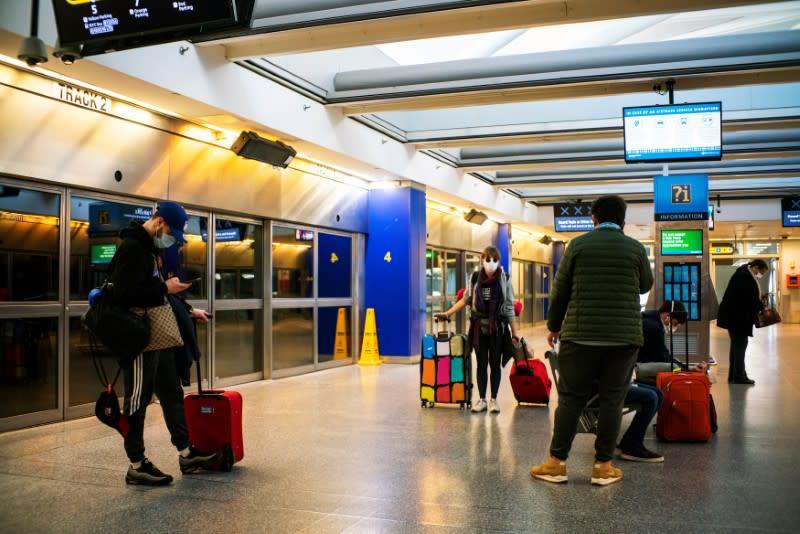 People walk around terminals after the Federal Aviation Administration (FAA) temporarily halted flights arriving at New York City airports due to coronavirus disease (COVID-19) in New York