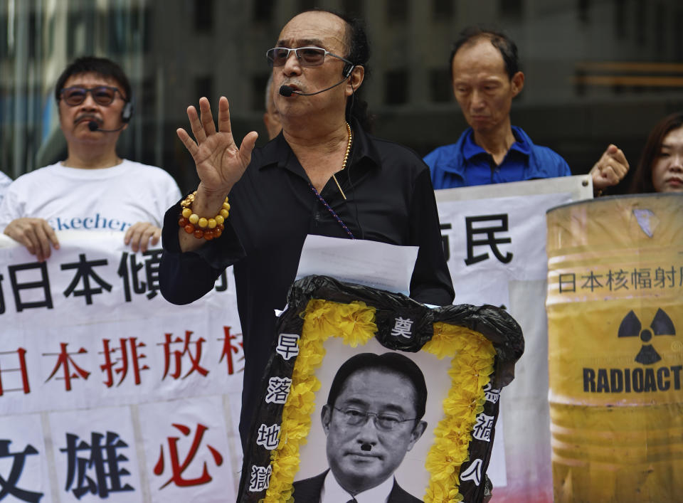 A protester holds up a funeral portrait depiction of Japanese Prime Minister Fumio Kishida during a protest against the discharge of treated Fukushima radioactive wastewater, outside the Japan general-consulate in Hong Kong, on Thursday, Aug. 24, 2023. The Hong Kong authorities have imposed a ban on imports of Japanese seafood as a gesture to oppose Japan's decision to discharge the treated radioactive water from the wrecked Fukushima nuclear power plant. (AP Photo/Daniel Ceng)