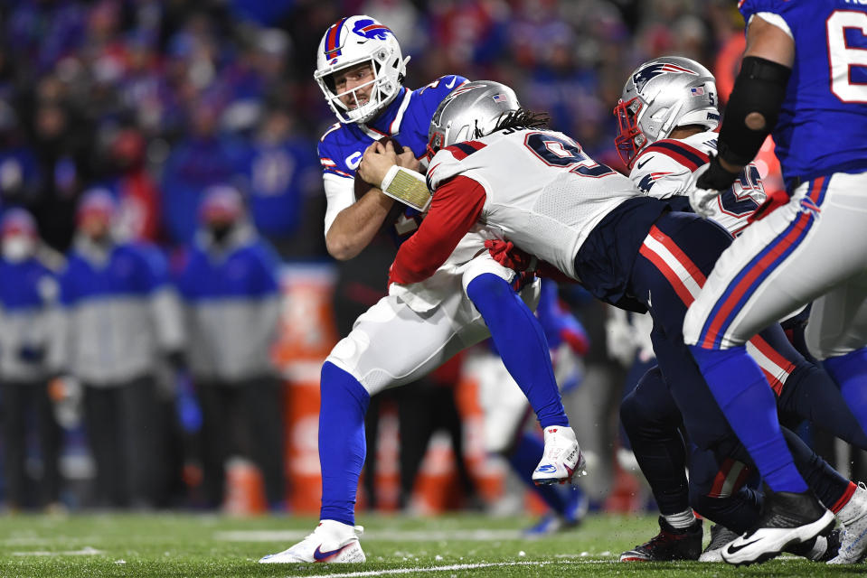 Buffalo Bills quarterback Josh Allen (17) is tackled by New England Patriots outside linebacker Matt Judon (9) during the first half of an NFL football game in Orchard Park, N.Y., Monday, Dec. 6, 2021. (AP Photo/Adrian Kraus)