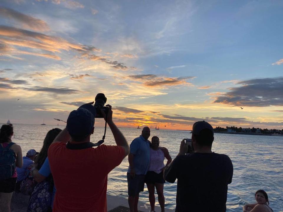 People take photographs of a Key West sunset on Oct. 15, 2020, at Mallory Square in Key West during the daily Sunset Celebration.