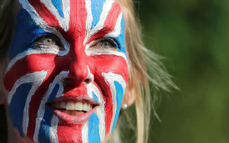 A woman with a Union Jack face painting looks on, ahead of Prince Harry and Meghan Markle's wedding in Windsor, Britain May 19, 2018. REUTERS/Marko Djurica