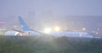 A Boeing passenger plane from China, a Xiamen Air, lies on the grassy portion of the runway of the Ninoy Aquino International Airport after it skidded off the runway while landing Friday, Aug. 17, 2018, in suburban Pasay city southeast of Manila, Philippines. All the passengers and crew of Xiamen Air flight MF8667 are safe and were taken to an airport terminal, where they were given blankets and food before being taken to a hotel. (AP Photo/Bullit Marquez)