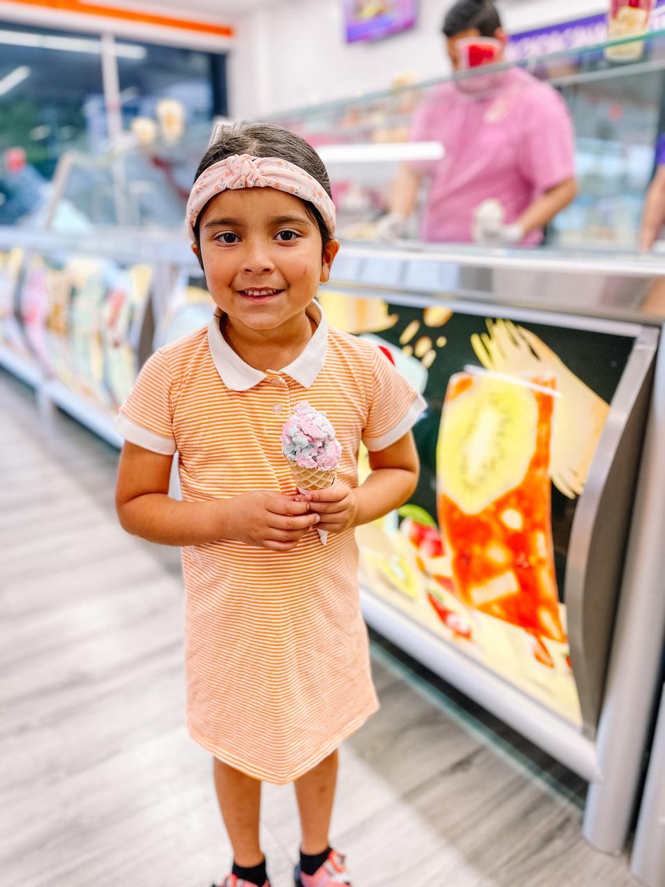 Genesis Galvez enjoys her ice cream at La Michoacana Movil in South Knoxville on March 31.