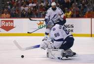 Tampa Bay Lightning goaltender Andrei Vasilevskiy (88) makes a stop against the Florida Panthers as defenseman Zach Bogosian (24) looks on during the second period of Game 1 of an NHL hockey second-round playoff series Tuesday, May 17, 2022, in Sunrise, Fla. (AP Photo/Reinhold Matay)