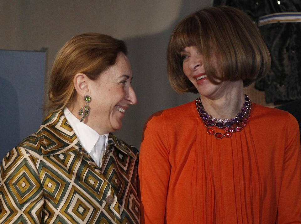 American Vogue's editor-in-chief Anna Wintour, right, talks to Italian fashion designer Miuccia Prada during the presentation of the fashion exhibition "Impossible Conversations" in Milan, Italy, Friday, Feb.24, 2012. The exhibition will take place at the Metropolitan Museum of Art in New York, from May 10 to August 19, 2012. (AP Photo/Luca Bruno)