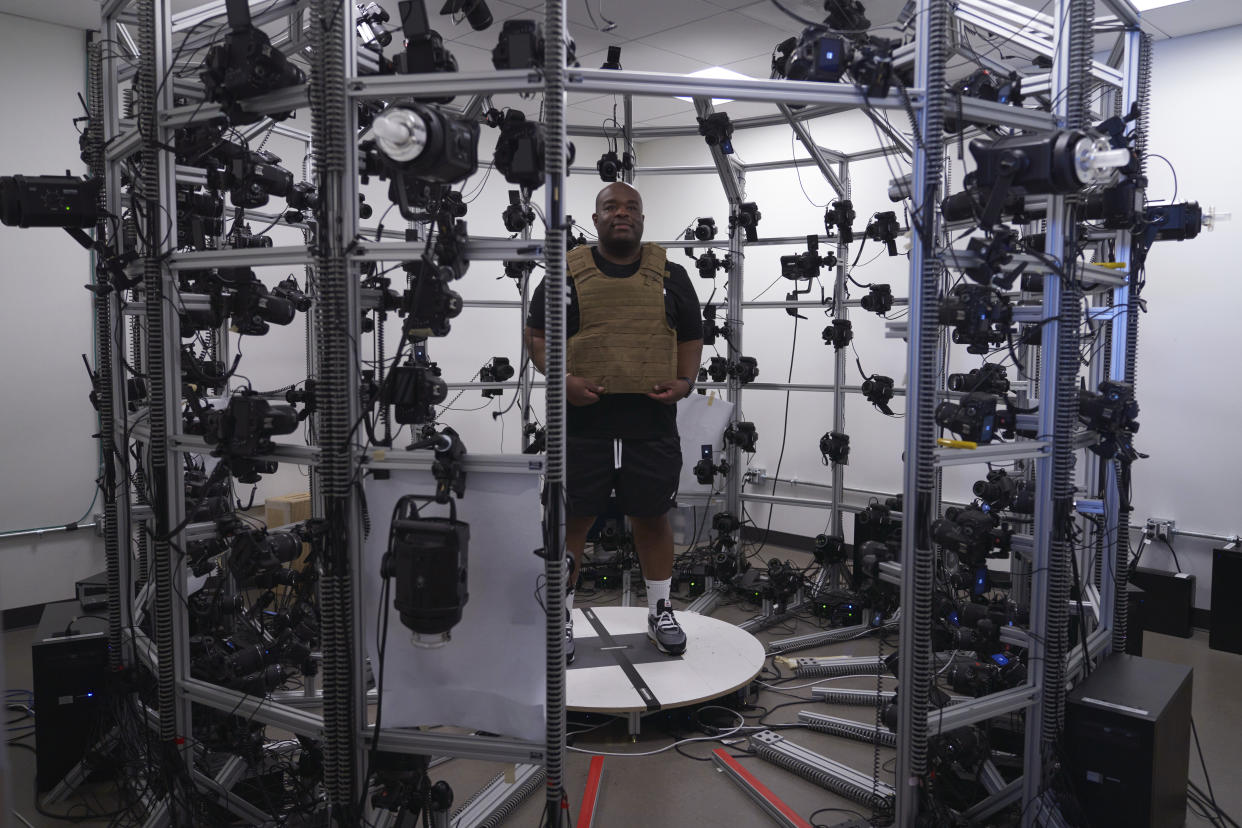 A man wears a bulletproof vest that is mapped in a photogrammetry room for the video game series Call of Duty on Friday, Oct. 21, 2022, at Activision Blizzard, Infinity Ward Division, in Woodland Hills, Calif. Call of Duty has been one of the best-selling video games for the past decade-plus, and is at the heart of the developing antitrust fight over whether Microsoft will be able to acquire Activision Blizzard. (AP Photo/Allison Dinner)