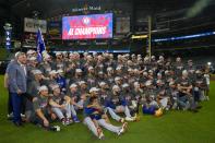 The Texas Rangers pose for a team photo after Game 7 of the baseball AL Championship Series against the Houston Astros Monday, Oct. 23, 2023, in Houston. The Rangers won 11-4 to win the series 4-3. (AP Photo/Godofredo A. Vásquez)