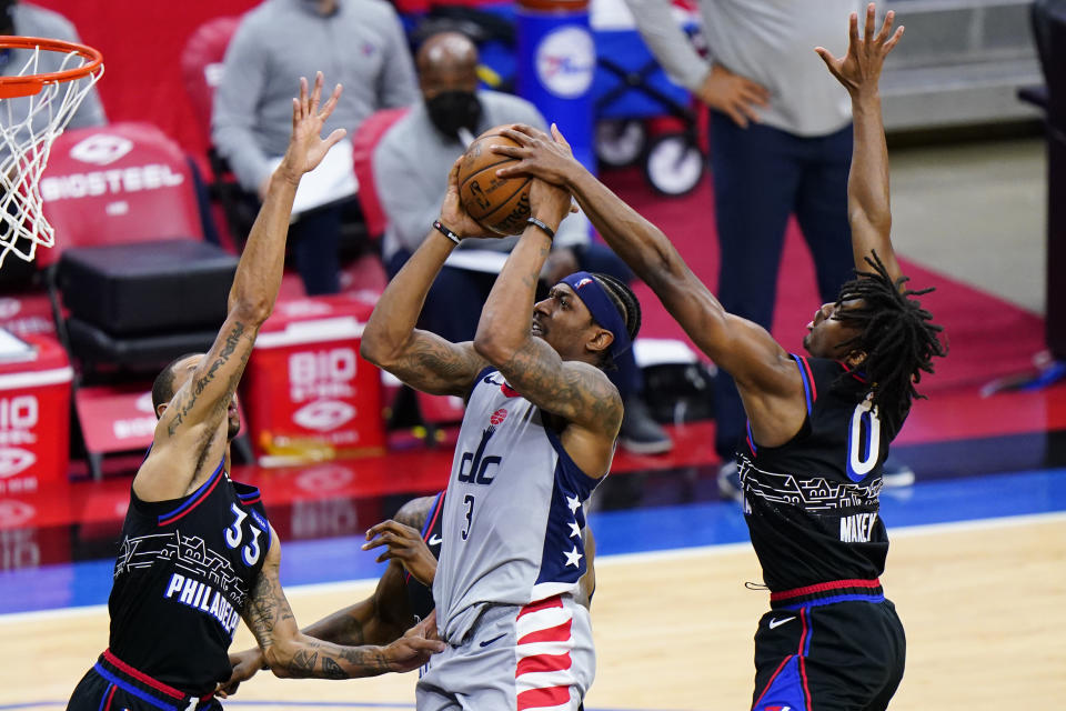 Washington Wizards' Bradley Beal, center, goes up for a shot against Philadelphia 76ers' George Hill, left, and Tyrese Maxey during the second half of Game 2 in a first-round NBA basketball playoff series, Wednesday, May 26, 2021, in Philadelphia. (AP Photo/Matt Slocum)