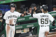 Pittsburgh Pirates' Jack Suwinski, right, is greeted by Kevin Newman after hitting a solo home run to tie the game against the St. Louis Cardinals during the eighth inning of a baseball game, Monday, Oct. 3, 2022, in Pittsburgh. (AP Photo/Keith Srakocic)