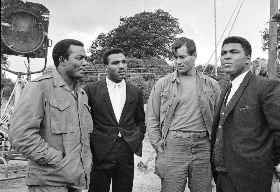 FILE 0 Muhammad Ali visits the film set of "The Dirty Dozen" with, from left, Jim Brown, Rahaman Ali, Clint Walker at Morkyate, Bedfordshire, England, Aug. 5, 1966. NFL legend, actor and social activist Jim Brown passed away peacefully in his Los Angeles home on Thursday night, May 18, 2023, with his wife, Monique, by his side, according to a spokeswoman for Brown's family. He was 87. (AP Photo/File)