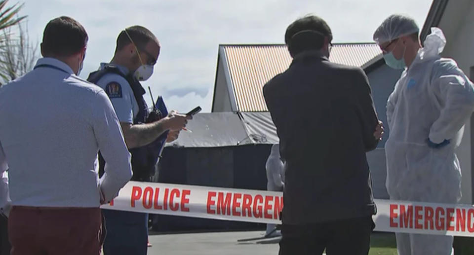 Police are pictured at the home in Timaru, New Zealand, where three girls were found dead.