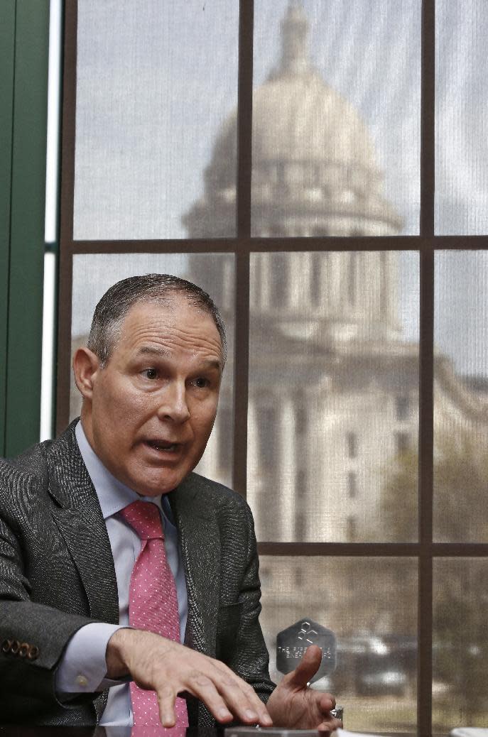 FILE - In this March 10, 2016 file photo, Scott Pruitt, Oklahoma Attorney General, gestures as he speaks during an interview in Oklahoma City. The Oklahoma Capitol is at rear. Pruitt is President-elect Donald Trump's nominee to head the Environmental Protection Agency. (AP Photo/Sue Ogrocki, File)