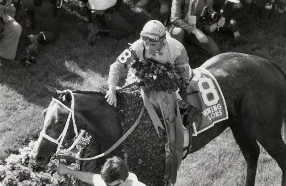 Jockey Gary Stevens congratulates 1988 Kentucky Derby winner Winning Colors after the filly was presented with the blanket of roses.