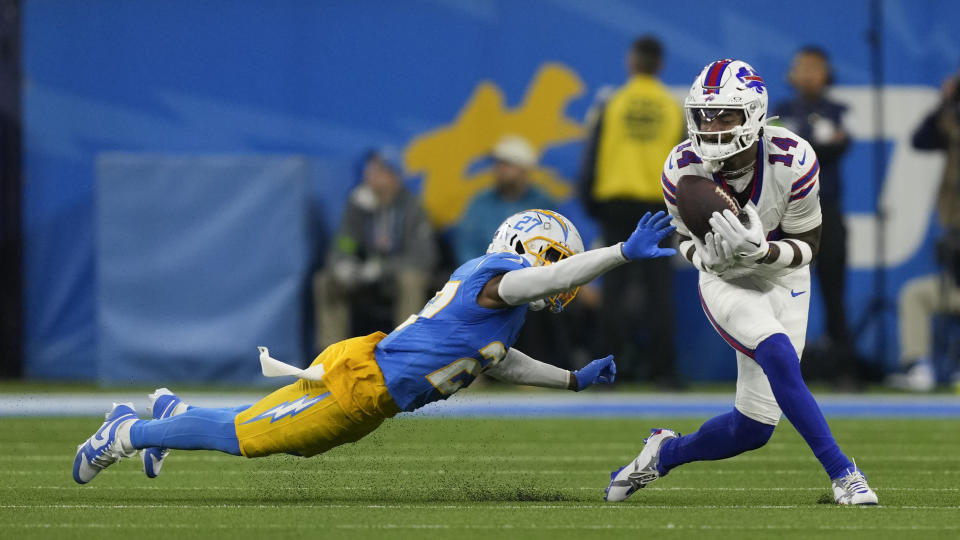 Buffalo Bills wide receiver Stefon Diggs (14) makes a catch in front of Los Angeles Chargers cornerback Essang Bassey (27) during the second half of an NFL football game Saturday, Dec. 23, 2023, in Inglewood, Calif. (AP Photo/Ryan Sun)