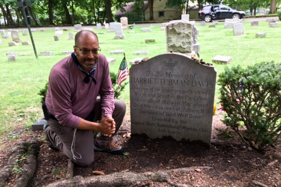 Ken Johnston kneels next to Harriet Tubman's tombstone in Auburn, N.Y. (Courtesy Ken Johnston)