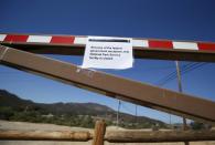 A sign is seen on the gate of Paramount Ranch indicating the National Park Service site is closed in the Santa Monica mountains, Agoura Hills, California, October 1, 2013. The White House rejected a Republican plan to reopen portions of the U.S. government on Tuesday as the first shutdown in 17 years closed landmarks like the Statue of Liberty and threw hundreds of thousands of federal employees out of work. REUTERS/Lucy Nicholson (UNITED STATES - Tags: POLITICS BUSINESS)