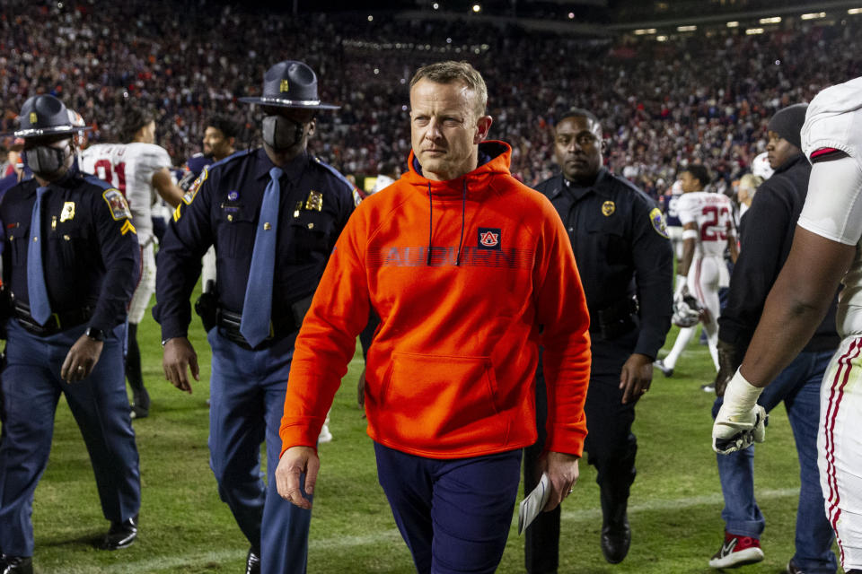 Auburn head coach Bryan Harsin walks off the field after a 24-22 4-overtime loss to Alabama in an NCAA college football game, Saturday, Nov. 27, 2021, in Auburn, Ala. (AP Photo/Vasha Hunt)