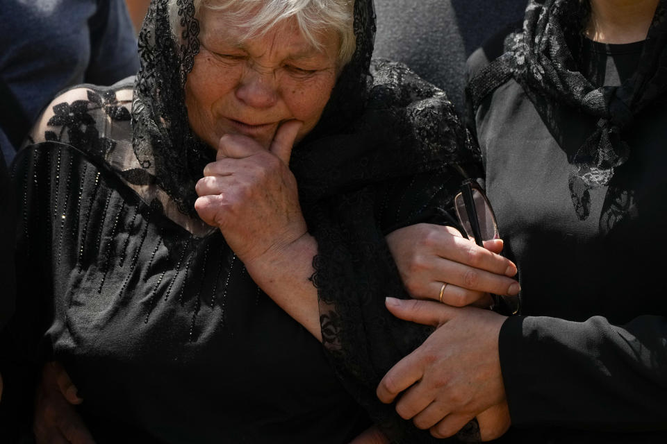 The mother of Army Col. Oleksander Makhachek cries during his funeral in Zhytomyr, Ukraine, Friday, June 3, 2022. According to combat comrades Makhachek was killed fighting Russian forces when a shell landed in his position on May 30. (AP Photo/Natacha Pisarenko)