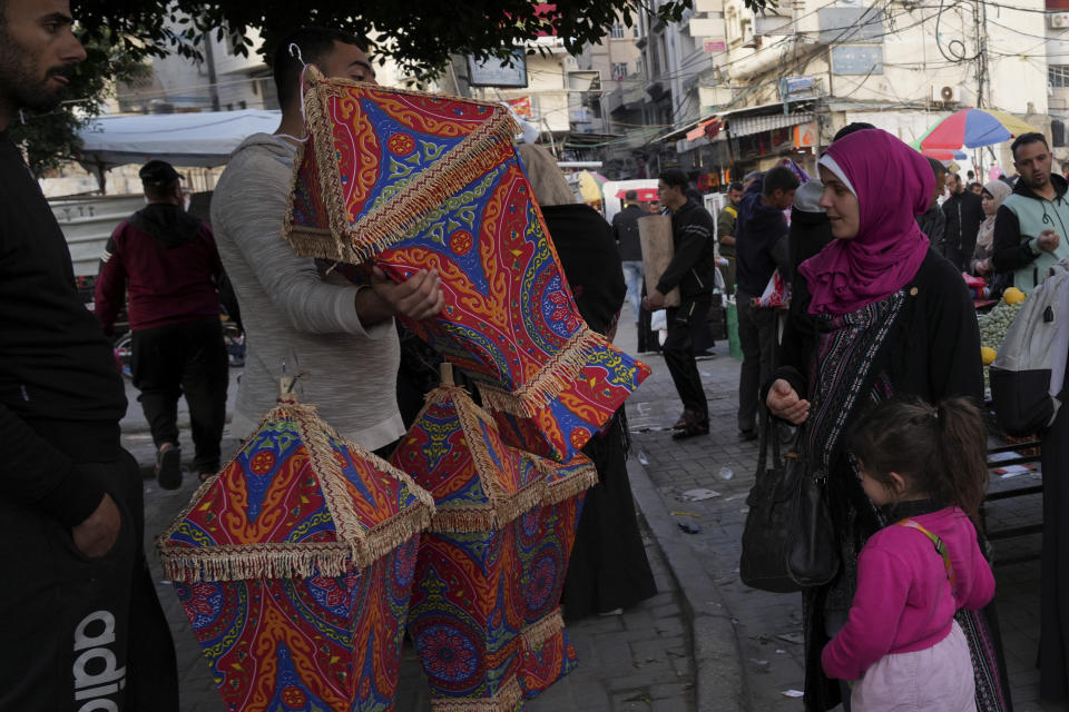 A woman and her daughter shop traditional lantern for the Muslim holy month of Ramadan, at al-Zawya traditional market in Gaza City, Thursday, March 31, 2022. As Ramadan begins with the new moon next week, Muslims around the world are trying to maintain their religious rituals of Islamic holiest month. (AP Photo/Adel Hana)