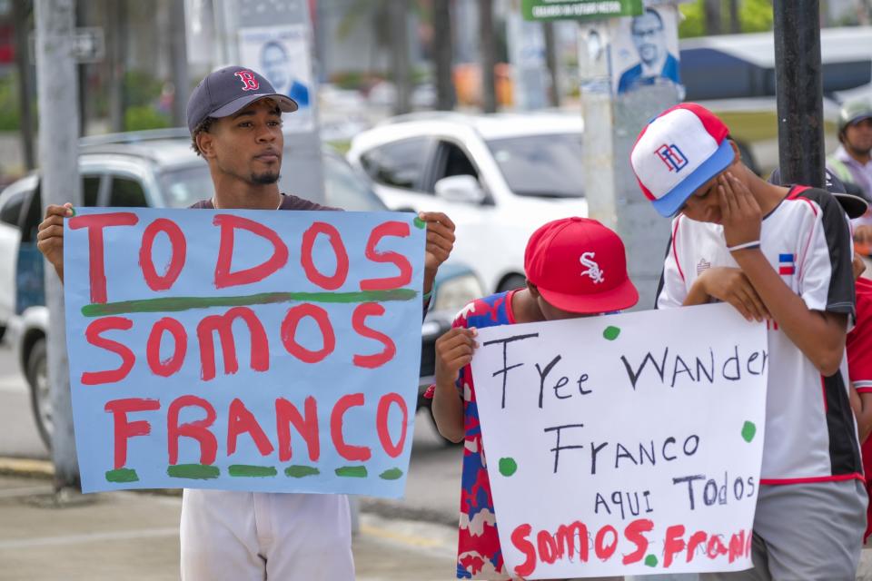 Youth baseball players from the local team "Liga deportiva Antera Mota" show support for Tampa Bay Rays shortstop Wander Franco with posters that read in Spanish: "Free Franco," and "We all are Franco." outside the court where he arrived in Puerto Plata, Dominican Republic, Friday, Jan. 5, 2024. Dominican prosecutors on Wednesday accused Franco of commercial sexual exploitation and money laundering following allegations that he had a relationship with a minor whose mother also faces the same charges. (AP Photo/Ricardo Hernández)