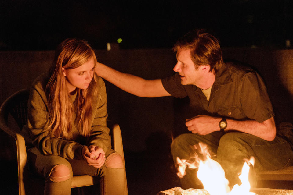 Josh Hamilton rubs Elsie Fisher's shoulder near a campfire