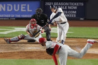 New York Yankees Gio Urshela connects on a pitch from Philadelphia Phillies relief pitcher Deolis Guerra (57) for a three-run, home run during the sixth inning of a baseball game, Monday, Aug. 3, 2020, at Yankee Stadium in New York. Phillies catcher J.T. Realmuto (10) is behind the plate. (AP Photo/Kathy Willens)