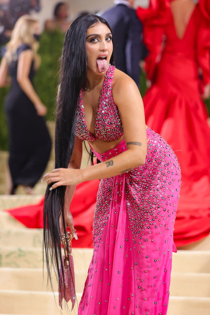 Lourdes in a sparkling gown playfully sticking out her tongue on the Met Gala stairs