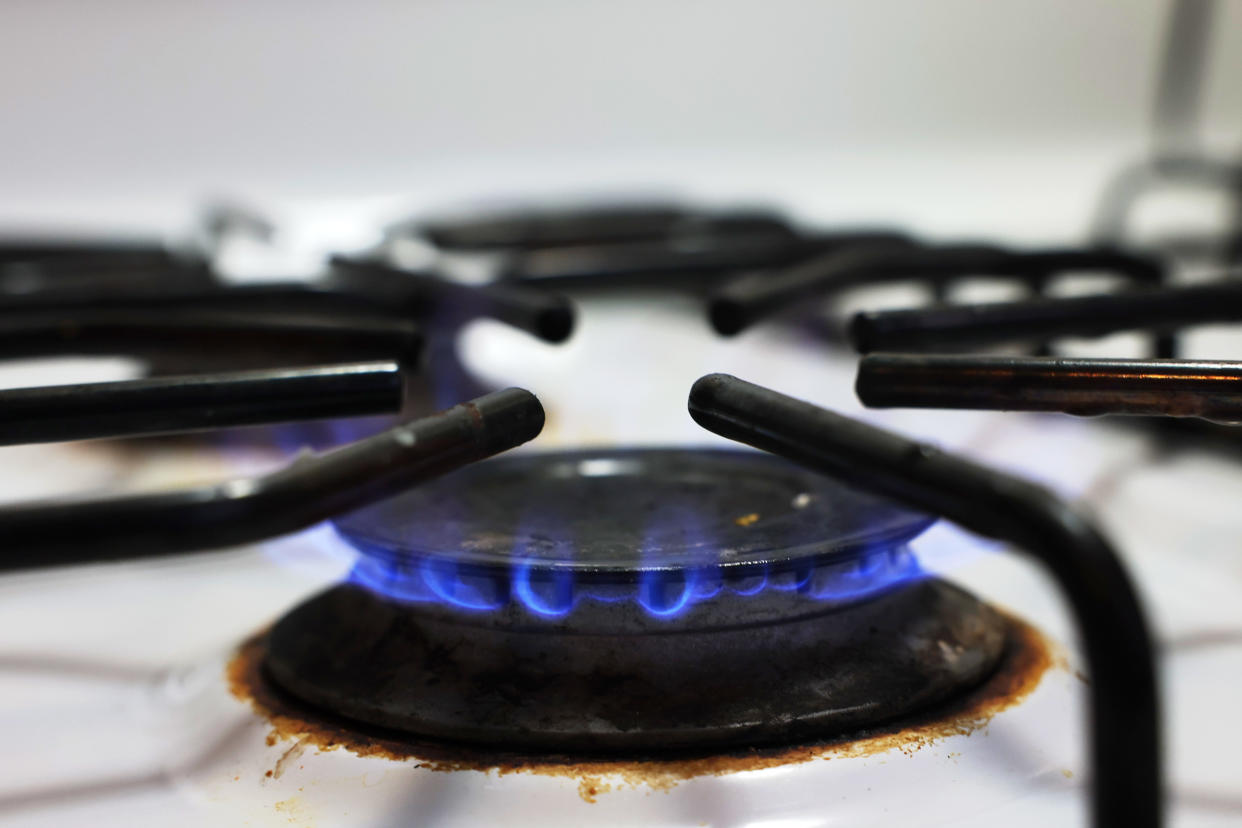 A flame burns on a gas stove. 