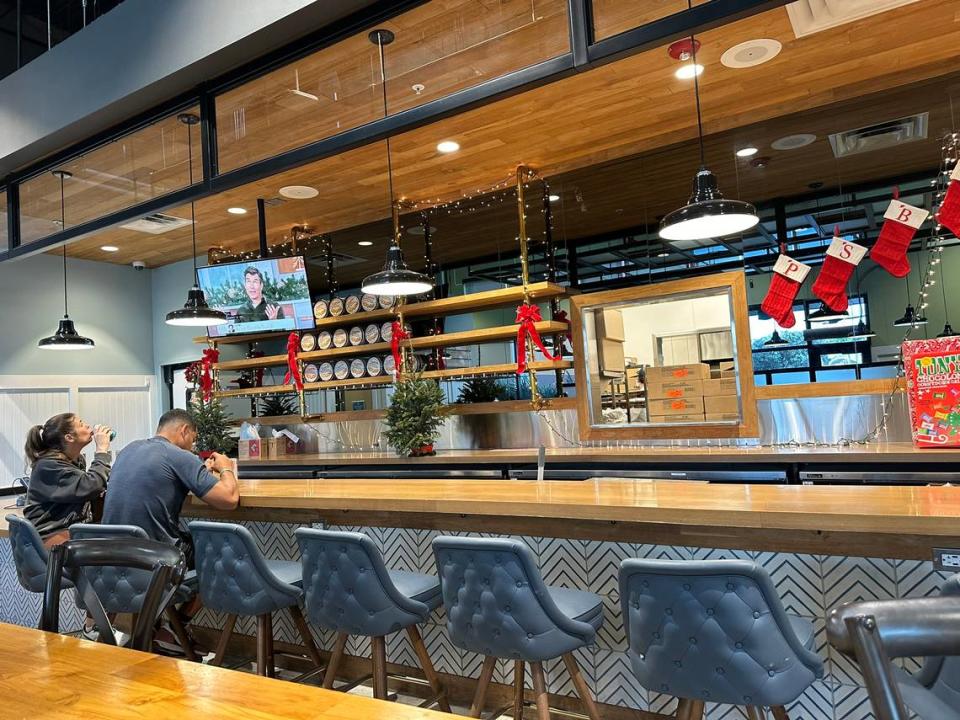 Customers dine inside a Whole Foods Market cafe and bar area in Pinecrest on Dec. 7, 2023.