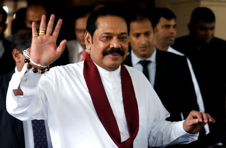 Sri Lanka's newly appointed Prime Minister Mahinda Rajapaksa waves at the staff after participating in the ceremony to assume his duties as the Minister of Finance and Economic Affairs at the Finance Ministry in Colombo, Sri Lanka October 31, 2018. REUTERS/Dinuka Liyanawatte