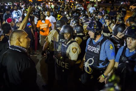 St Louis County police officers interact with anti-police demonstrators during protests in Ferguson, Missouri August 10, 2015. REUTERS/Lucas Jackson